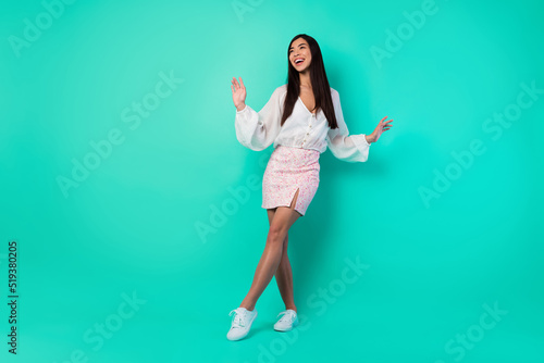 Full size photo of excited cheerful vietnamese person dancing partying isolated on vivid aquamarine color background