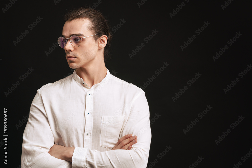 Young handsome man in shirt and glasses with folded arms Young handsome man in shirt and glasses with folded arms