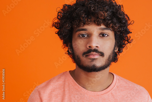 Portrait of young indian handsome curly calm man © Drobot Dean