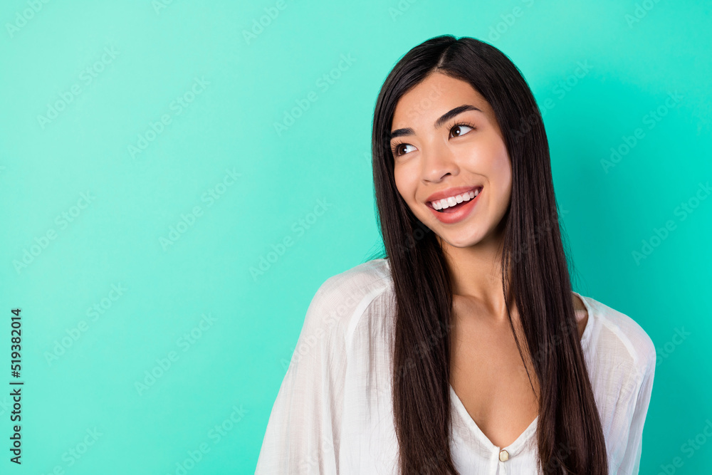 Photo of gorgeous positive person toothy smile look interested empty space isolated on shine aquamarine color background Photo of gorgeous positive person toothy smile look interested empty space isolated on shine aquamarine color background