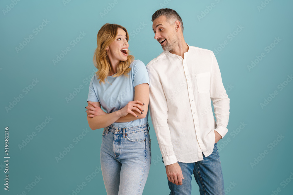 White surprised couple exclaiming and looking at each other White surprised couple exclaiming and looking at each other