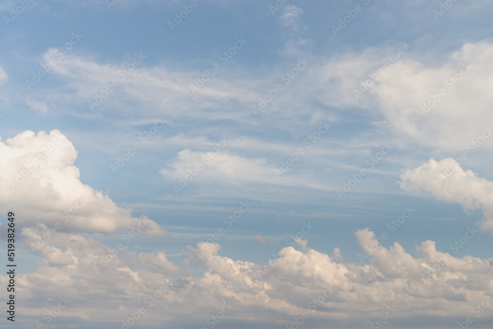 Beautiful well balanced sky replacement background with layers of fluffy white cumulus clouds on a blue sky background. Beautiful well balanced sky replacement background with layers of fluffy white cumulus clouds on a blue sky background.
