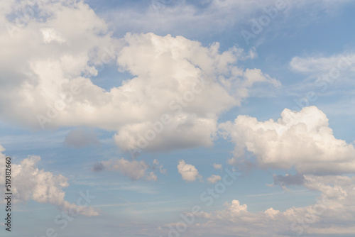 Beautiful well balanced sky replacement background with layers of fluffy white cumulus clouds on a blue sky background.