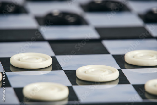 Background, checkers board with checkers, checkers is logical game for two.