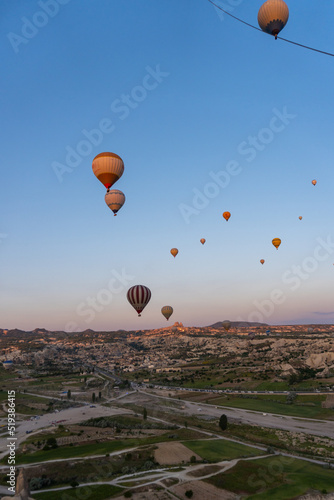 Landscape of Cappadocia, at sunrise with hot air balloons flying, view from a hot air balloon