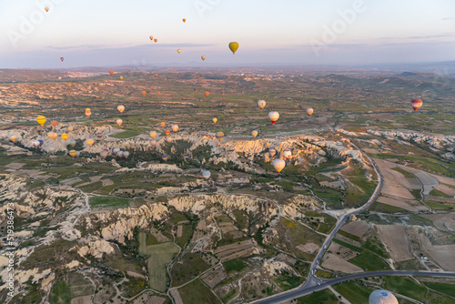 Landscape of Cappadocia, at sunrise with hot air balloons flying, view from a hot air balloon