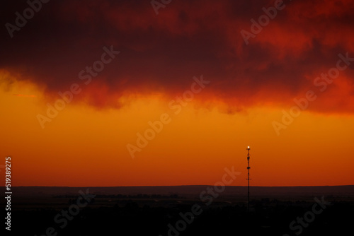 Cell Tower for Digital Communication at Sunset Silhouette