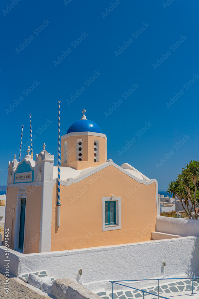 Beautiful view of a church with a blue dome in Oia, Santorini island, Greece