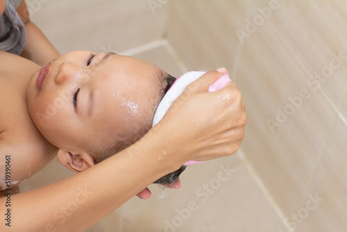 baby boy taking a shower and wash hair by mother in the bathroom, 80 week old, child kid concept, Mom cleaning her baby hair with sponge