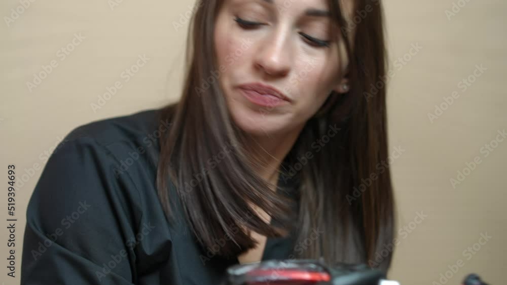 Portrait of confident focused professional tattoo master with tattoo machine doing permanent lips nakeup for client in beauty salon. Concentrated Caucasian expert beautician tattooing facial skin Portrait of confident focused professional tattoo master with tattoo machine doing permanent lips nakeup for client in beauty salon. Concentrated Caucasian expert beautician tattooing facial skin