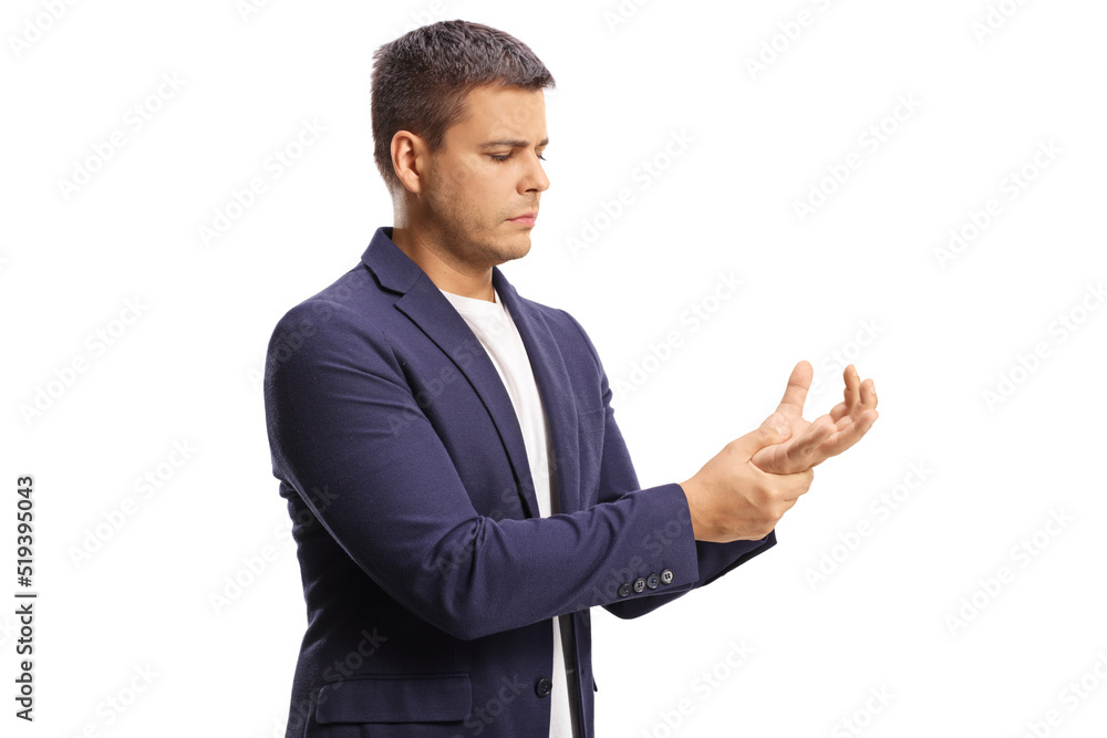Young man suffering from arthritis and holding his painful wrist Young man suffering from arthritis and holding his painful wrist