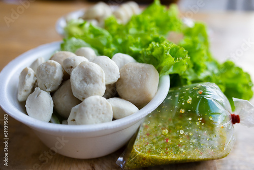 Boiled meatballs eat with spicy seafood sauce. Thai food.