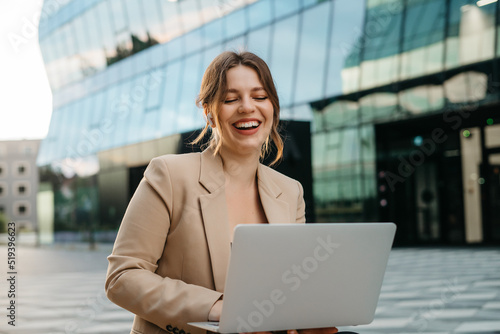 Portrait of a beautiful blonde business woman talking on the phone on the street