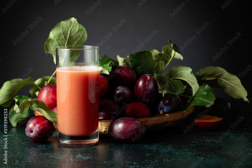 Plum juice and fresh purple plums. Plum juice and fresh purple plums.