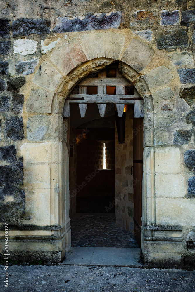 Big stone gates of Blandy medieval castle with wooden door