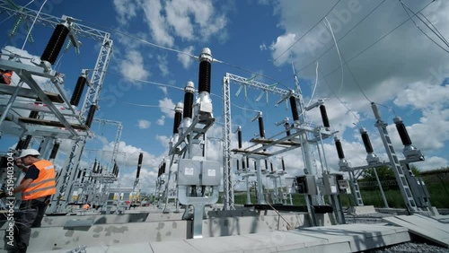 High voltage transformer against the blue sky. Electric current redistribution substation