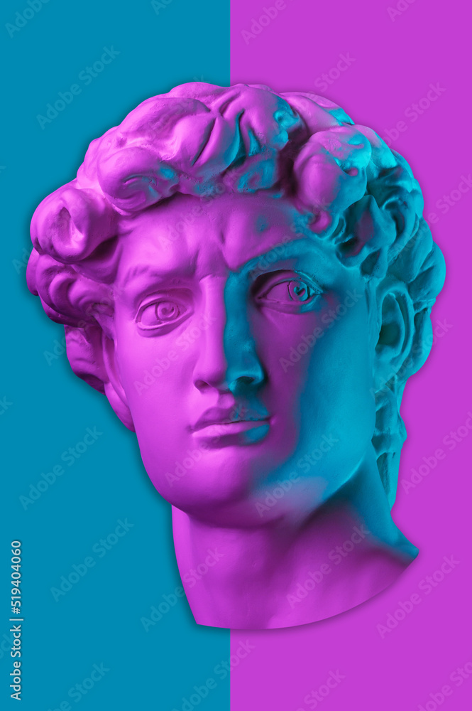 Gypsum copy of head statue David in bright neon colors for artists on a color background. Face famous sculpture youth of David by Michelangelo. Template design for dj, fashion, poster, zine, collage.