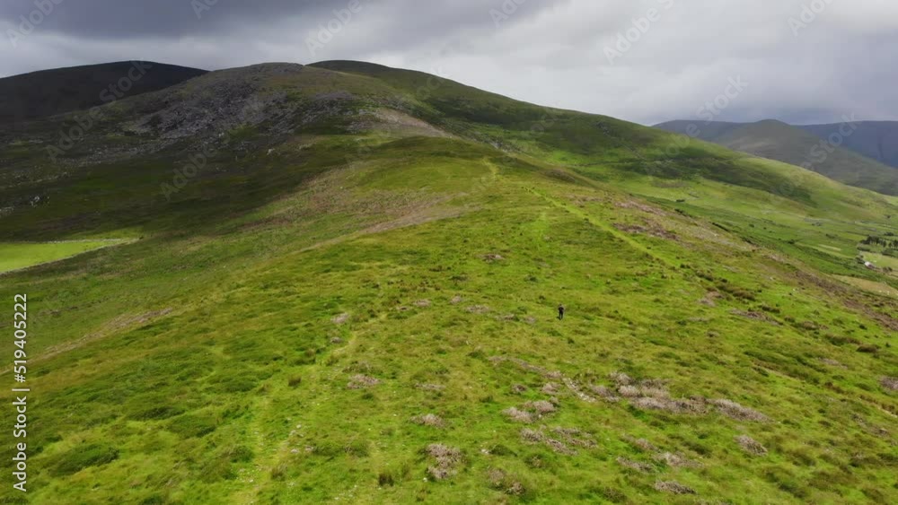 young man hiking on mountain in summer day Ireland young man hiking on mountain in summer day Ireland