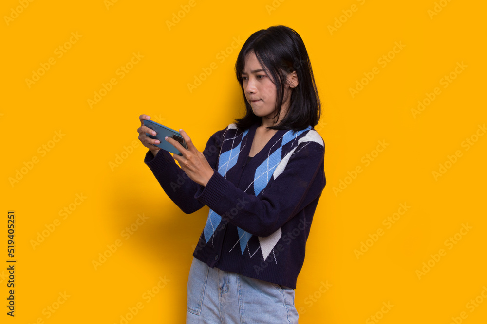 happy young asian beautiful woman using mobile phone isolated on yellow background
happy young asian beautiful woman using mobile phone isolated on yellow background
