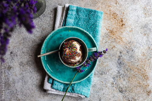 Overhead view of a cup of homemade chocolate and vanilla ice cream with sprinkles photo