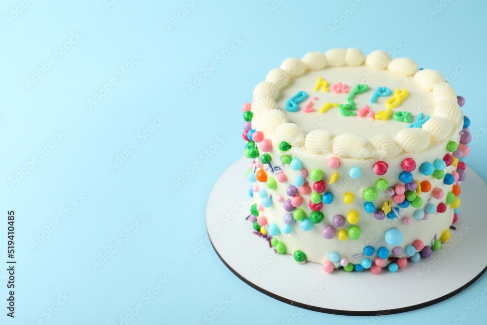 Cute bento cake with tasty cream on light blue background, space for text Cute bento cake with tasty cream on light blue background, space for text
