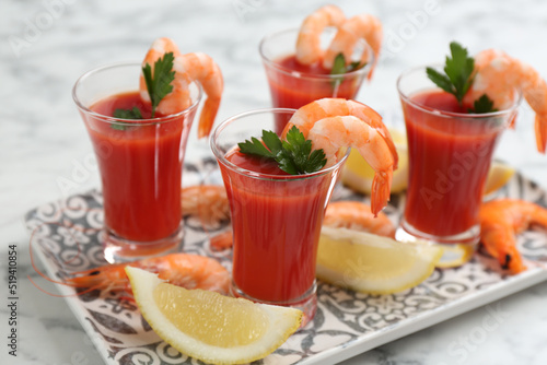 Shrimp cocktail with tomato sauce served on marble table