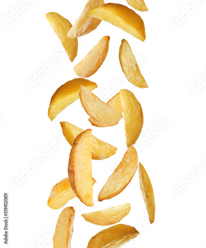 Tasty baked potatoes falling on white background