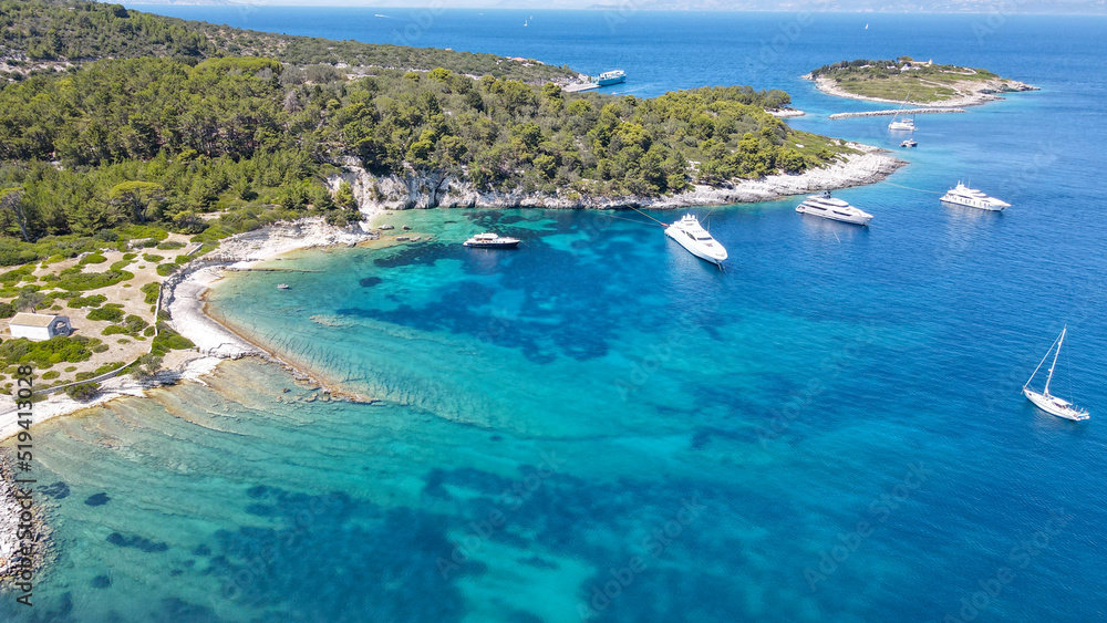 Scenic ionian islands of Greece - Paxos. Aerial drone photo of paradise bay an caves of blue lagoon in beautiful island of Paxos visited by yachts and sail boats, Ionian, Greece