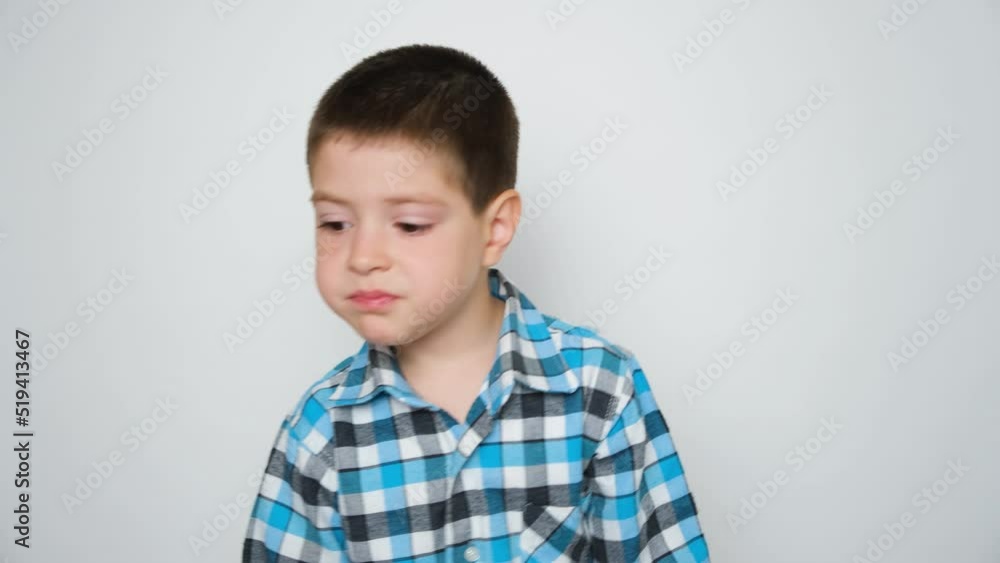 A 5-year-old boy eats carrots and leaves. Vegetables for children A 5-year-old boy eats carrots and leaves. Vegetables for children