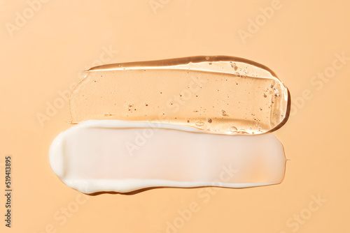 Liquid cream and gel cosmetic smudge drops texture on beige background. cosmetic smears cream texture photo