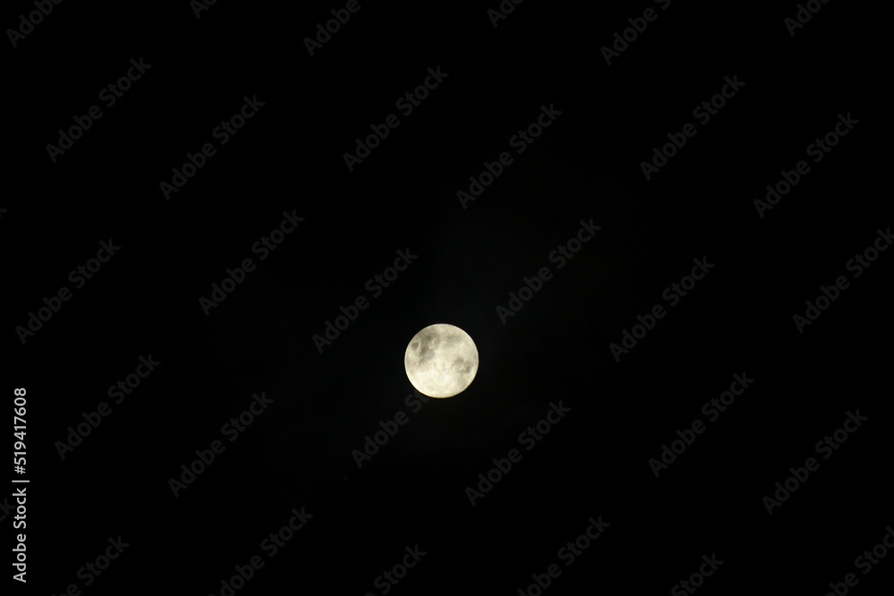 Full moon on the dark sky as a background. Jakarta, Indonesia. Full moon on the dark sky as a background. Jakarta, Indonesia.