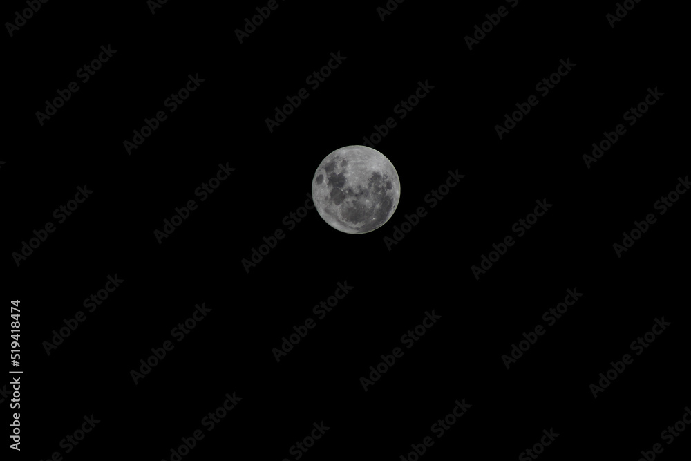 Full moon on the dark sky as a background. Jakarta, Indonesia. Full moon on the dark sky as a background. Jakarta, Indonesia.