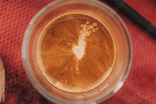 Close up top view of espresso coffee with beautiful crema in small glass.