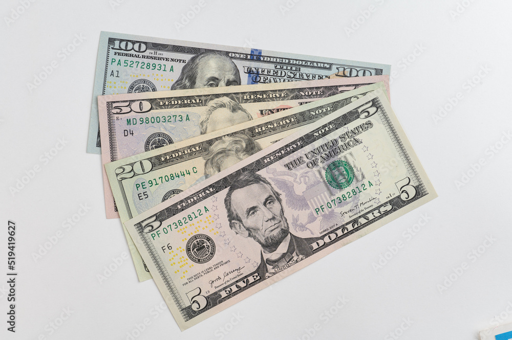 5, 20, 50, 100 dollars banknotes at different angles. Close up of dollars on white background. 5, 20, 50, 100 dollars banknotes at different angles. Close up of dollars on white background.