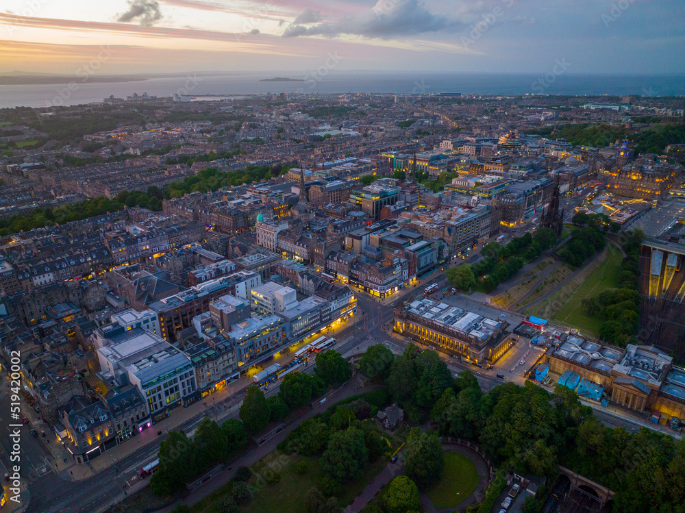 New Town and Scott Monument on Princes Street aerial view at sunset in Edinburgh, Scotland, UK. New town Edinburgh is a UNESCO World Heritage Site since 1995. 