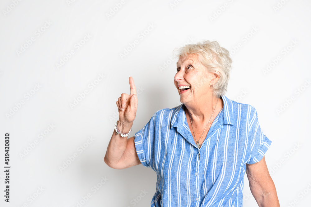 smiling retired senior woman looking at camera isolated on white background pointing something smiling retired senior woman looking at camera isolated on white background pointing something