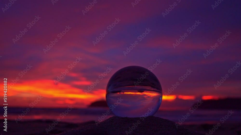 view of beautiful nature at sunset inside crystal ball..stunning sunset over sea in a crystal ball on the beach. .A image for a unique and creative travel..4K Videos for unusual travel ideas view of beautiful nature at sunset inside crystal ball..stunning sunset over sea in a crystal ball on the beach. .A image for a unique and creative travel..4K Videos for unusual travel ideas