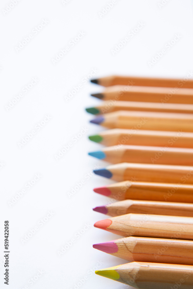 wooden colored pencils on blank page of a notebook wooden colored pencils on blank page of a notebook