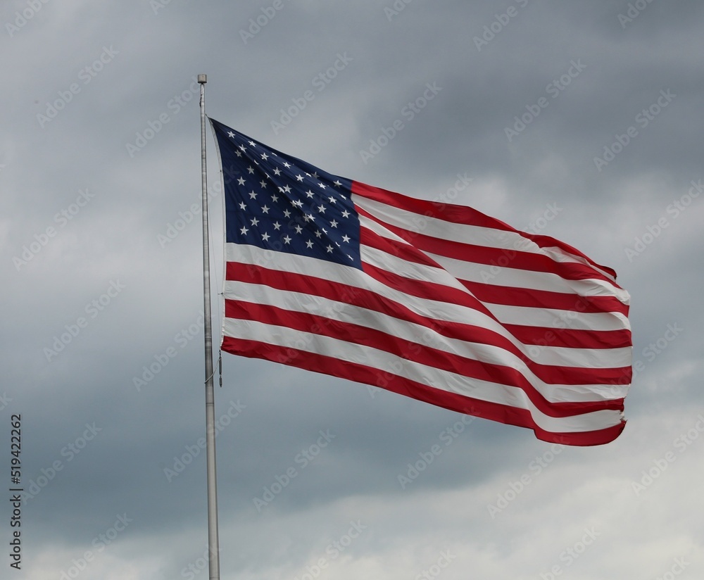 Obraz premium American Flack Flying High with Cloudy Background