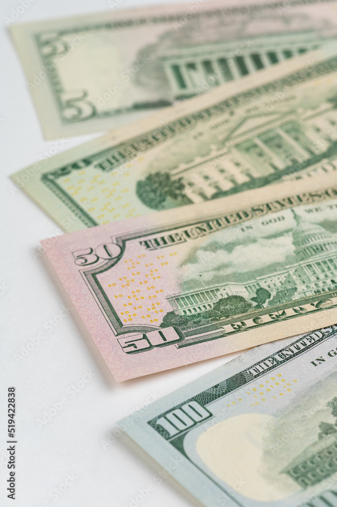 5, 20, 50, 100 dollars banknotes at different angles. Close up of dollars on white background. 5, 20, 50, 100 dollars banknotes at different angles. Close up of dollars on white background.