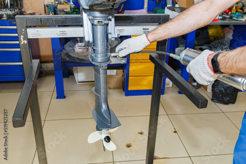 The master carries out maintenance of the boat motor.
