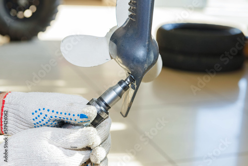 The master carries out maintenance of the boat motor.
