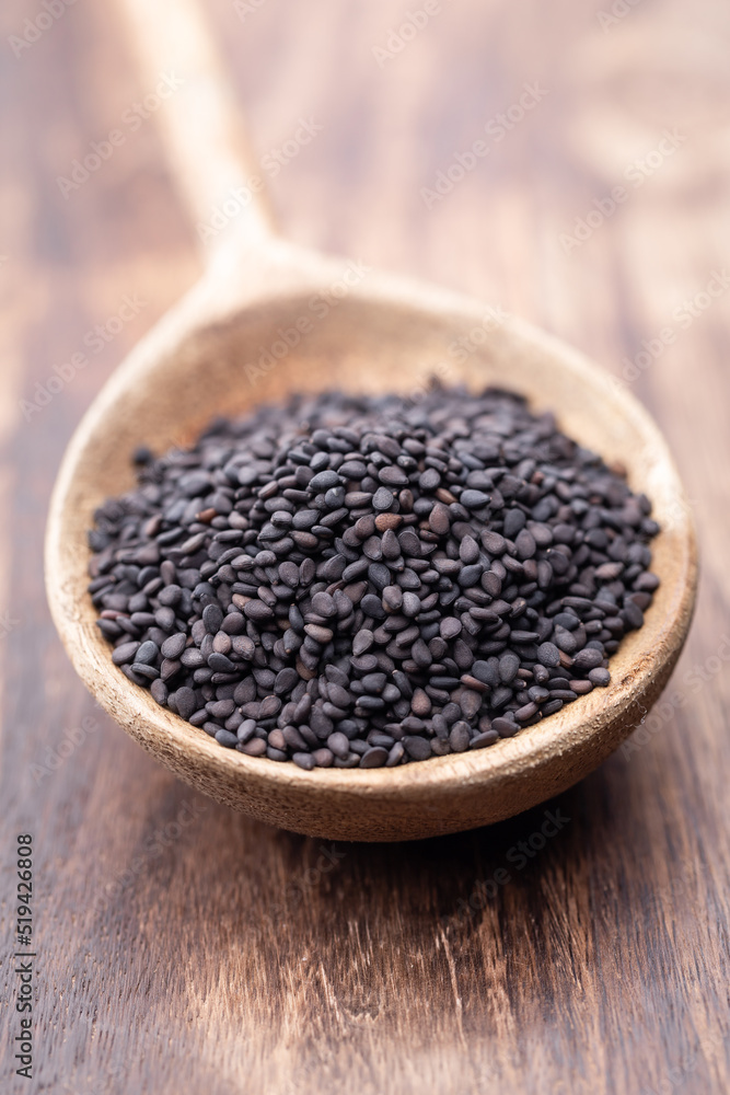 Bio natural black sesame seeds on wooden spoon. Bio natural black sesame seeds on wooden spoon.
