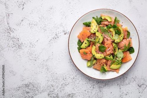 Salmon salad with avocado, for keto and low carb diet. Rusty background, top view, copy space.