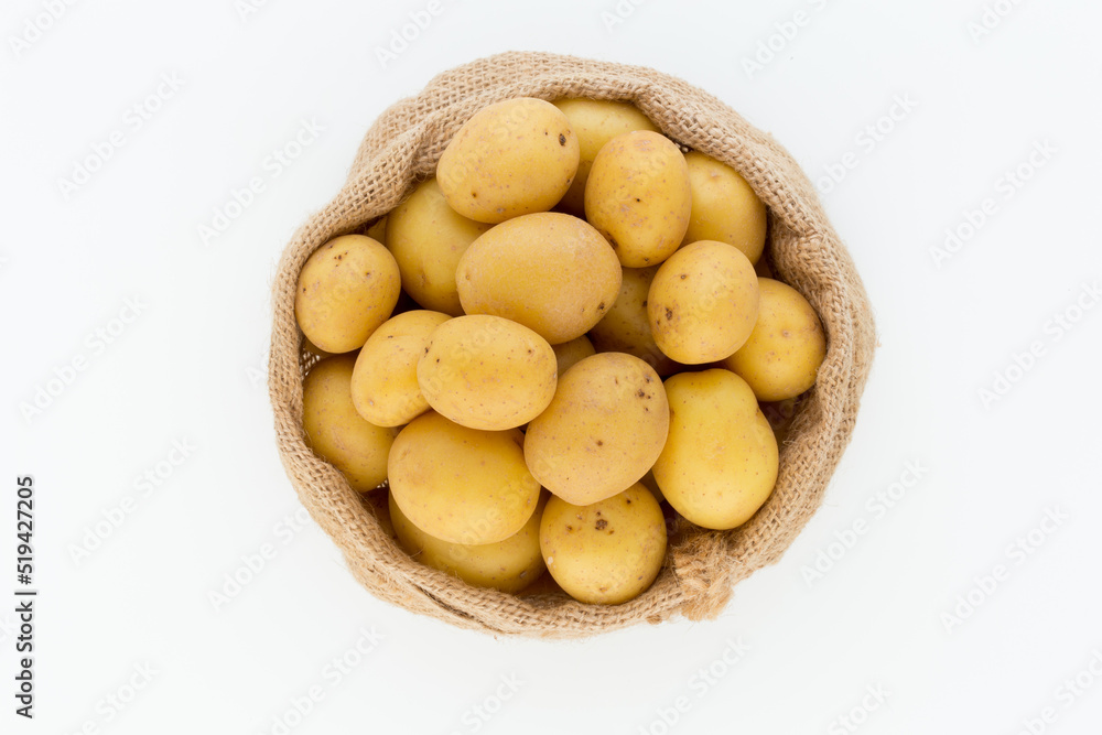 Sack of fresh raw potatoes on wooden background, top view Sack of fresh raw potatoes on wooden background, top view