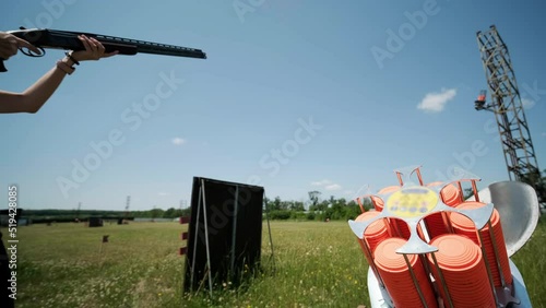 Sportsman shoots from a double-barreled shotgun, A sports field for a shooting test is shooting at flying skeet photo