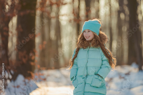 little girl in a winter forest and turquoise-colored clothes © zokov_111