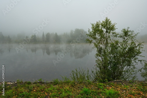 Russia. South of Western Siberia, Kuznetsk Alatau. Foggy autumn morning on the rocky bank of the Tom River near the village of Chulzhan.