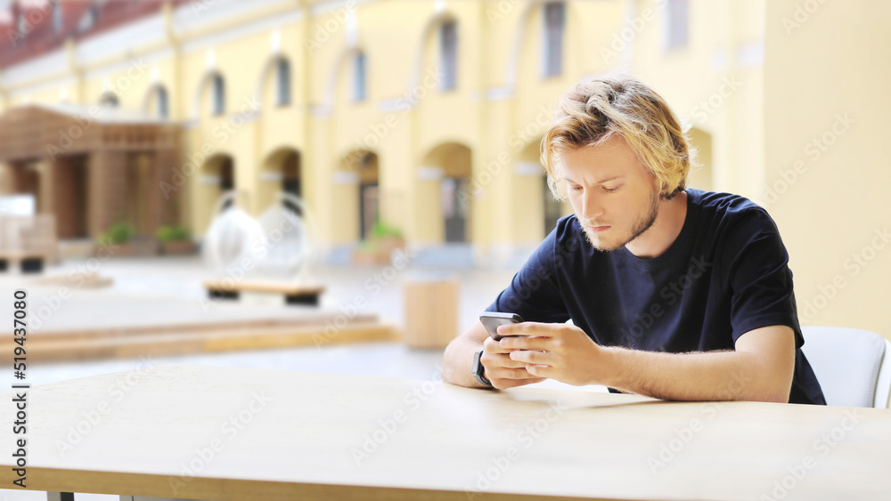 Lifestyle portrait of a young man using a smart phone outdoors Lifestyle portrait of a young man using a smart phone outdoors