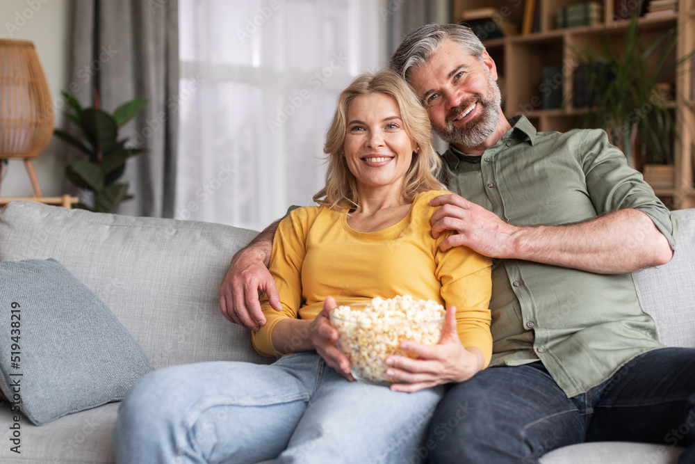 Happy Married Middle Aged Couple Watching Tv And Eating Popcorn At Home Happy Married Middle Aged Couple Watching Tv And Eating Popcorn At Home